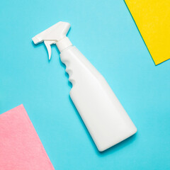 Microfiber, sponge and a cleaning spray on blue, top view. Cleaning supplies.
