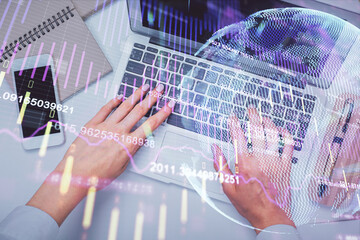 Double exposure of woman hands working on computer and forex graph hologram drawing. Top View. Financial analysis concept.