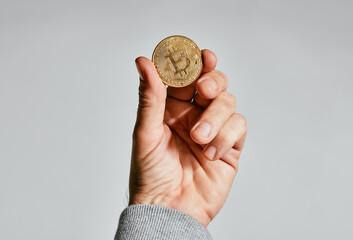 Bitcoin in hand, popular cryptocurrency coin
