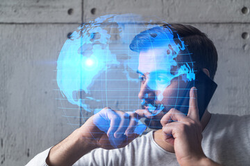 A man in casual wears, speaks phone. Double exposure. Planet Earth World map hologram.