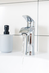 Luxury faucet mixer tap and white sink in beautiful white bathroom