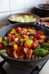 Hot Traditional Hungarian dish na frying pan - letcho with sausage, zucchini and paprika