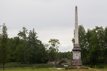 Stone pillar monument in summer green park