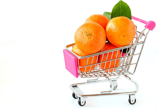 Fresh juicy sweet tangerines lie in a basket on an isolated white background.