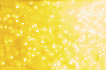 Abstract blurred yellow sparkle bakground.