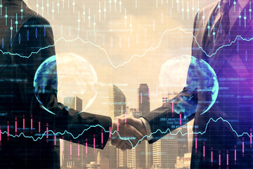 Double exposure of forex graph hologram and handshake of two men. Stock market concept.