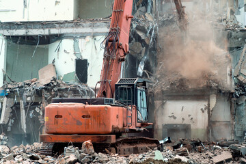 Old building Demolition works. Excavator demolishes an old building with special equipment