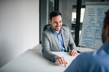 Confident businessman talking at the meeting in the office.
