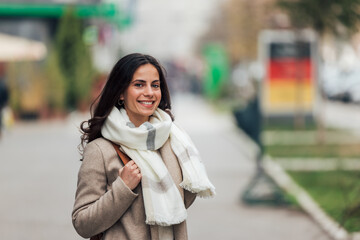 Looking good, wearing coat and scarf.