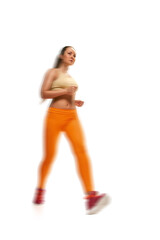 Beautiful young sporty woman running on white background