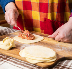  Woman making  manti  with minced beef meat