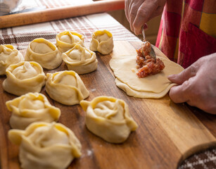  Woman making  manti  with minced beef meat