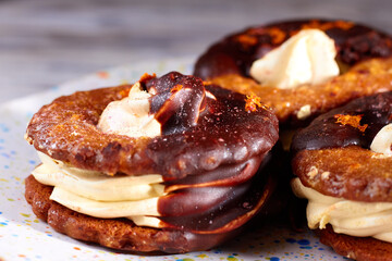 Close up of three homemade chocolate covered marshmallow crackers on plate