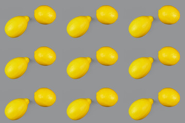 Two lemons on gray background.