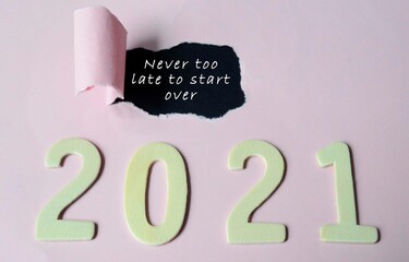 Never too late to start over text on torn paper with Year 2021 background