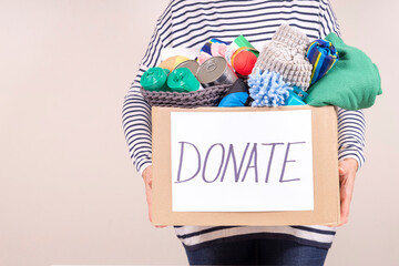 Volunteer holding donation box with animal food, pet goods and supplies for animal shelters