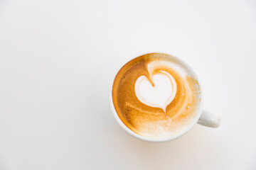cappuccino with heart shape, against white background. 