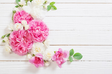 pink and white roses on white wooden background