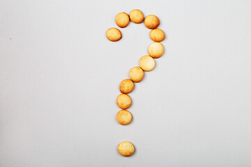 sweet biscuits laid out in the shape of a question mark