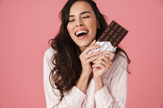 Joyful Woman In Party Cone Laughing While Posing With Chocolate