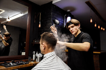 the process of men's haircuts in a stylish barbershop. men's hairdresser, beauty salon. close-up of the hands of a master who cuts a man with scissors. hairdressing accessories. stylish hairstyle