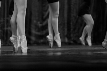 Grayscale closeup shot of ballet performers on stage