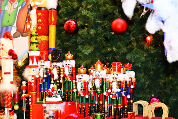 Cute and decorative wooden nutcrackers next to the Christmas green tree