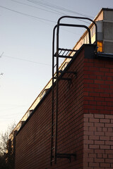 metal staircase leading to the roof of a brick building