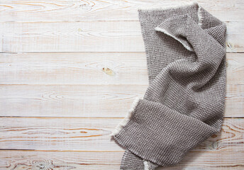 Gray linen napkin on white wooden table top view - close up