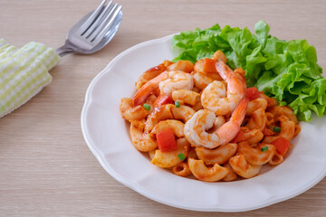 Stir fried macaroni with shrimp and vegetable on plate.
