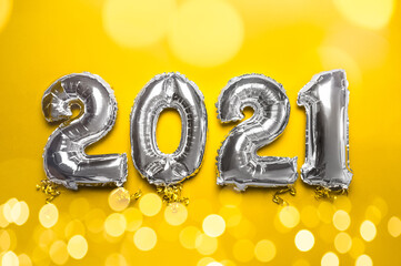 Balloon Bunting for celebration of New Year 2021 made from Silver Number Balloons. Holiday Party Decoration or postcard concept, trendy colors of 2021 of yellow and gray