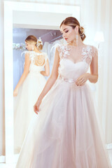 Naklejka premium Portrait of a beautiful young bride at the mirror.