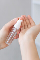 The antibacterial gel is applied to the hands. A bottle of moisturizing serum for the skin.