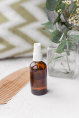 Hair spray in a glass bottle. In-kind care. Diy cosmetics prepared with your own hands.