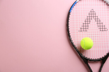 Tennis racket and ball on pink background, top view. Space for text