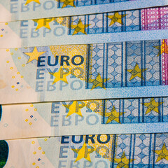 Twenty Euro bills on a wooden table, close-up, space for text