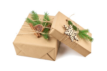 Two christmas gift boxes with fir tree branch and festive decorations isolated on white background