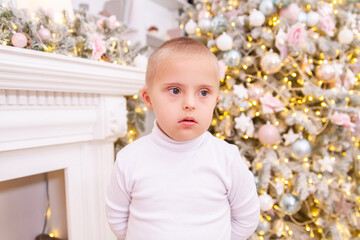Boy with Down syndrome at the Christmas tree, genetic anomaly, Christmas photography, disabled...