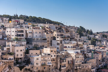 Fototapeta na wymiar Residential houses at the Mount of Olive and Kidron Valley under the sunlight in the morning in Jerusalem, Israel