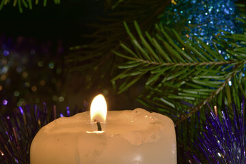Candles are burning by the Christmas tree. Happy Holidays!