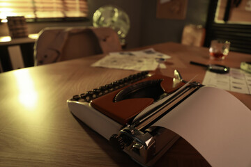 Fototapeta na wymiar Detective workplace with vintage typewriter on wooden table