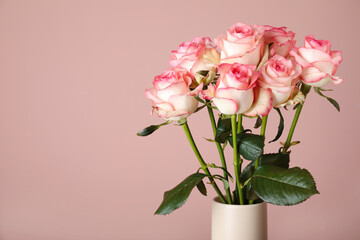 Vase with beautiful roses on pink background, closeup. Space for text