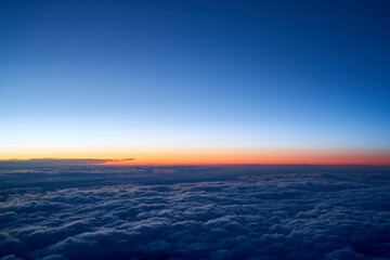 Evening sky with a low layer of clouds, just after sunset seen from an airplane