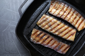 Delicious grilled eggplant slices in pan on grey table, top view