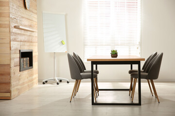 Modern meeting room interior with large table and chairs