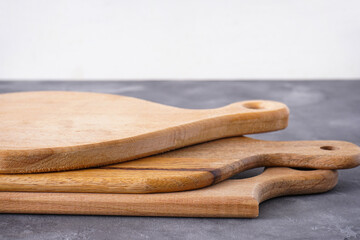 Cutting boards on a wooden background, close-up.