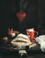 slice traditional European cake Stollen with nuts and candied fruit dusted with icing sugar