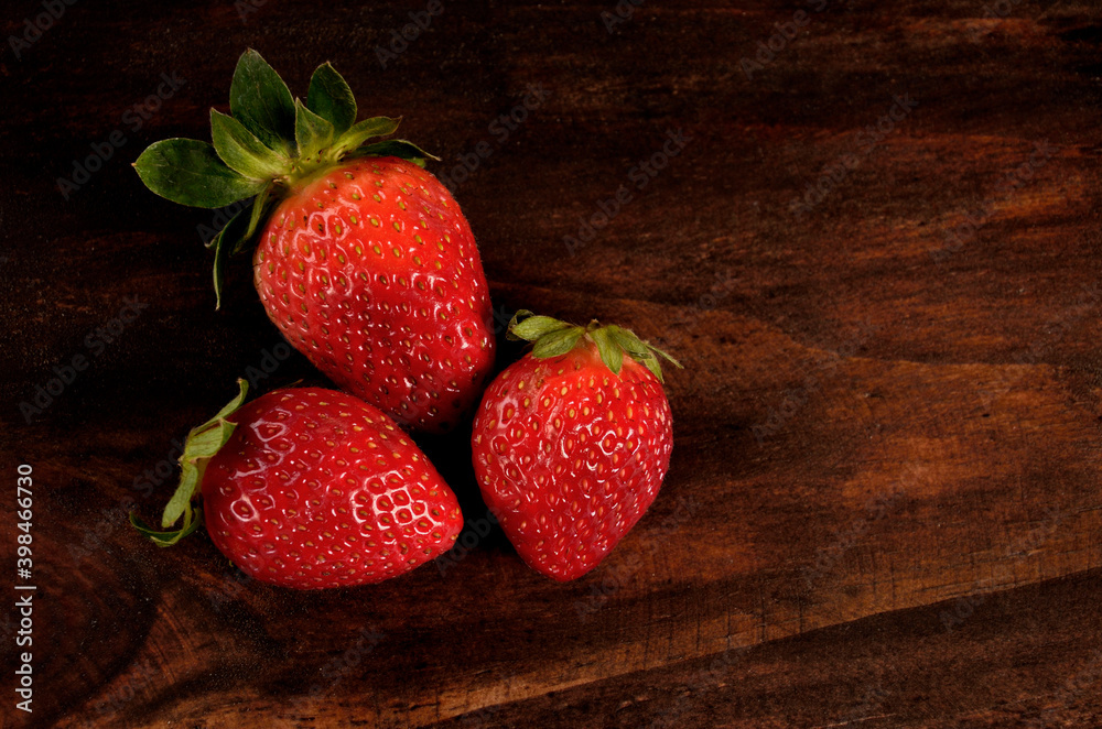 Wall mural three strawberries on the table