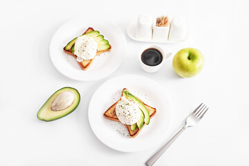Toast with poached eggs and avocado. Healthy breakfast and food. Cozy morning. Nutrition for pregnant. Diet for women. Breakfast in hotel room or bed. Scrambled eggs sandwich.