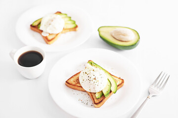 Toast with poached eggs and avocado. Healthy breakfast and food. Cozy morning. Nutrition for pregnant. Diet for women. Breakfast in hotel room or bed. Scrambled eggs sandwich.